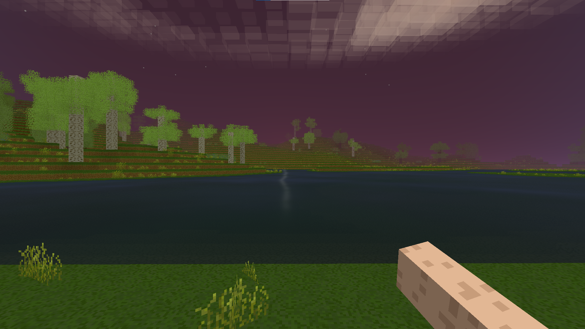 A purple dusk sky reflected on a still lake